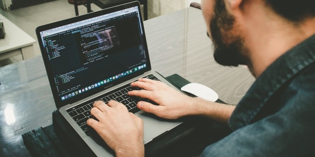 man typing on computer